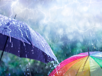 Heavy rain falling on a house roof and gutters during a summer storm